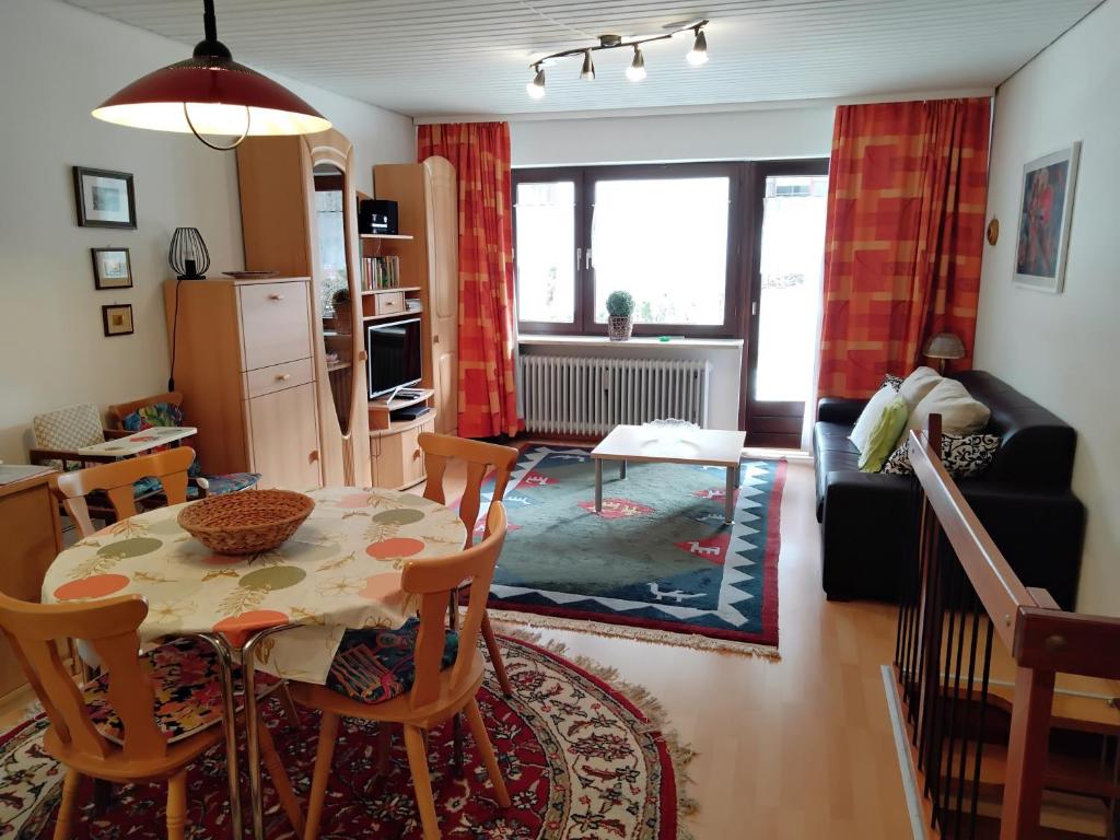 a kitchen and living room with a table and chairs at ciao-aschau Sachrang Haus Spitzstein FeWo Angelika in Aschau