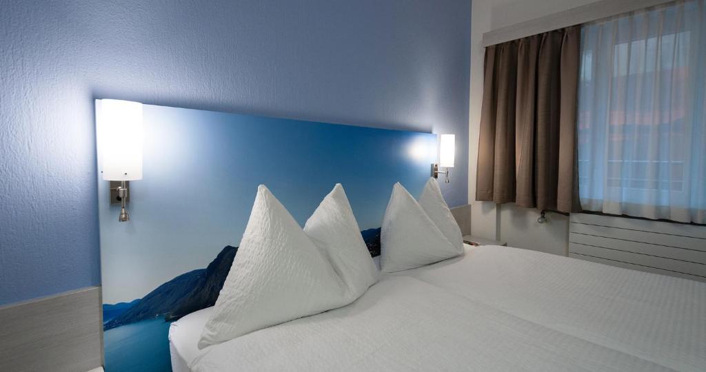 Letto o letti in una camera di Acquarello Swiss Quality Hotel