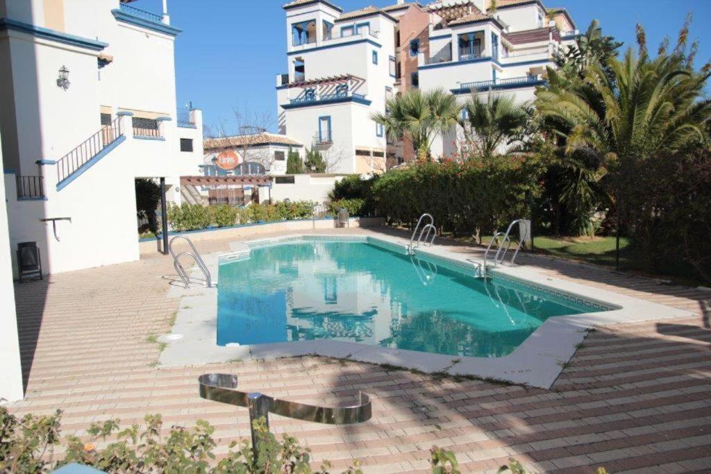 einem Pool vor einem Gebäude in der Unterkunft Marina II apartment in Huelva
