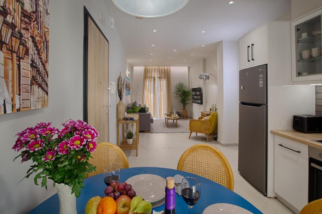 a kitchen and dining room with a table with fruit on it at Luxury Ap.Tennis in Ágios Rókkos