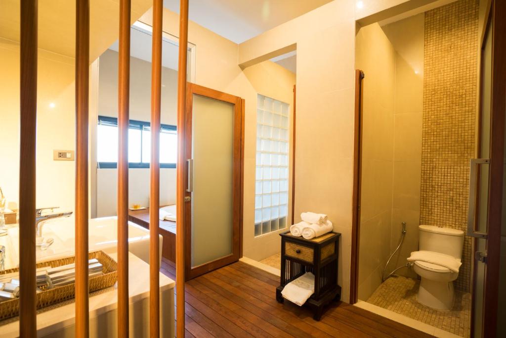 a small bathroom with a toilet and a sink at Amanta Hotel Nongkhai in Nong Khai