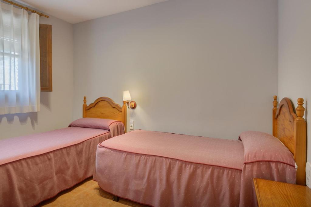 Cama o camas de una habitación en Apartamentos Casa Aurelia