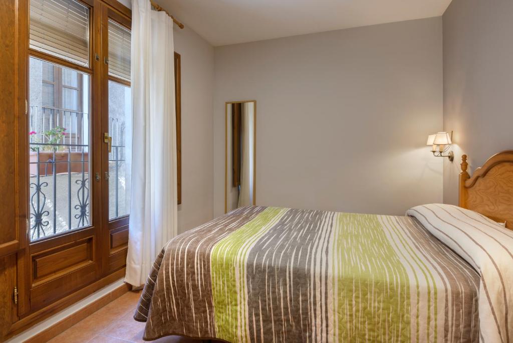 Cama o camas de una habitación en Apartamentos Casa Aurelia