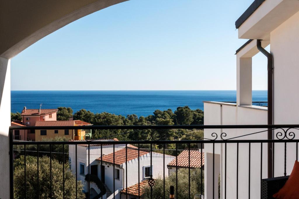 a view of the ocean from a balcony at Royal Suite Apartment in Cala Gonone