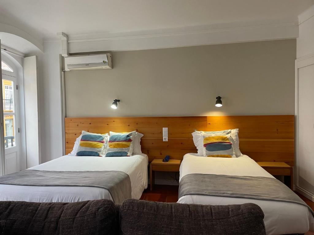 Postel nebo postele na pokoji v ubytování Hotel Ilha