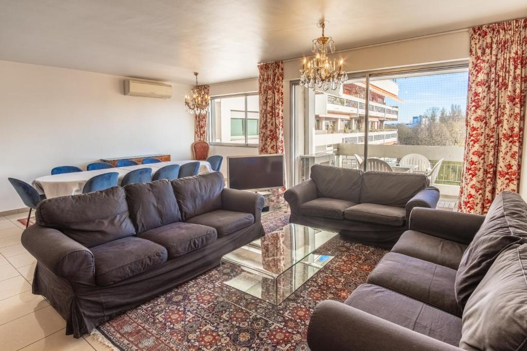 a living room with couches and a table at Appartement Mozart in Strasbourg