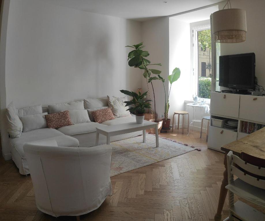 a living room with a white couch and a table at Maison Dolce Vita in Rome