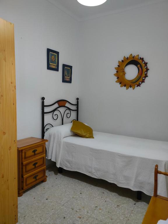sypialnia z 2 łóżkami i lustrem na ścianie w obiekcie Casa Noria w mieście Conil de la Frontera