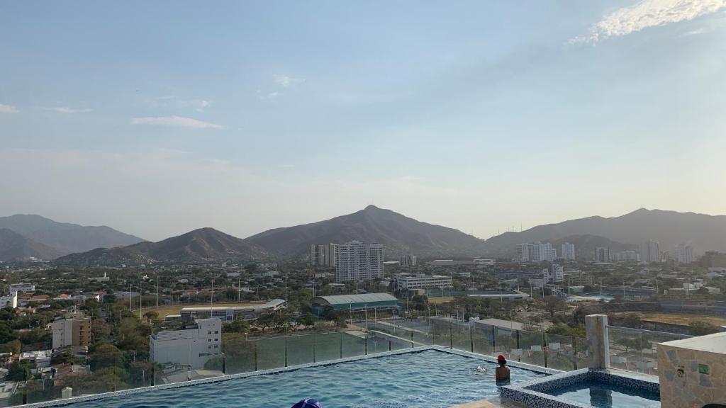 a view of a city from a swimming pool at Nuevo, amoblado y las mejores vistas de amaneceres in Santa Marta