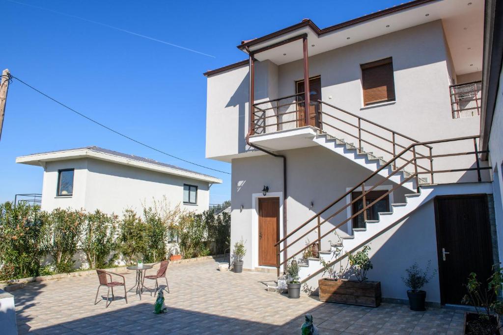 a white house with a staircase and a patio at Aspa's House in Limenas