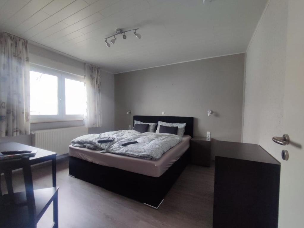 a bedroom with a large bed and a table at Gästehaus im Alten Fährhaus in Cochem