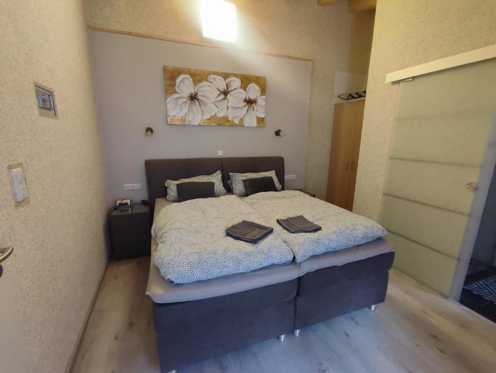 a bedroom with a bed with two books on it at Gästehaus im Alten Fährhaus in Cochem