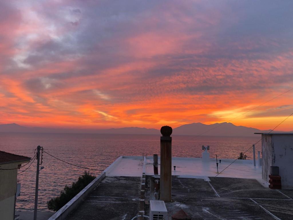 a sunset over the ocean from a cruise ship at Sea Sunset Appartment in Nea Iraklia