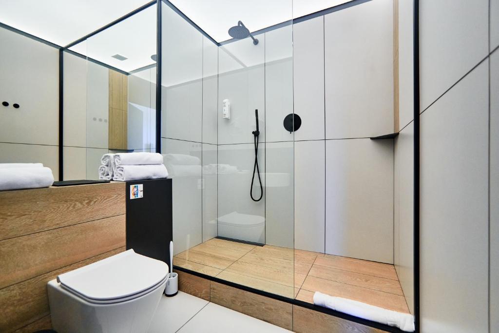 a bathroom with a shower and a toilet at Sunday Rooms in Odesa