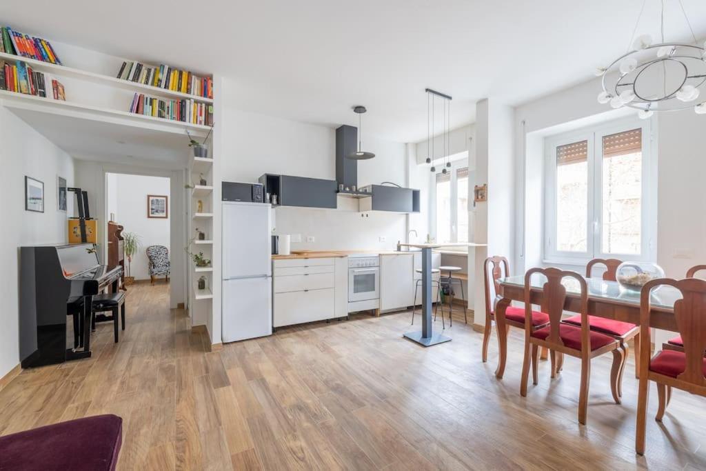 a kitchen and dining room with a table and chairs at HospitalityRome Casa Veronica in Rome