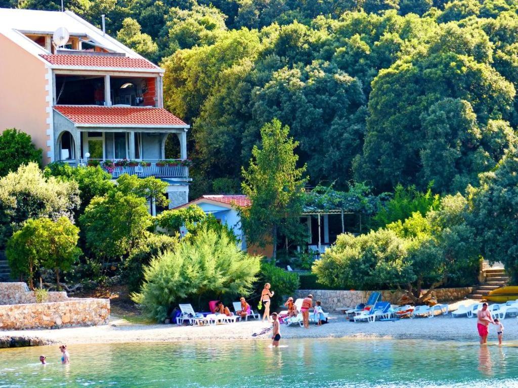 a group of people on a beach in the water at Apartments Villa Cebalo-Korčula in Korčula