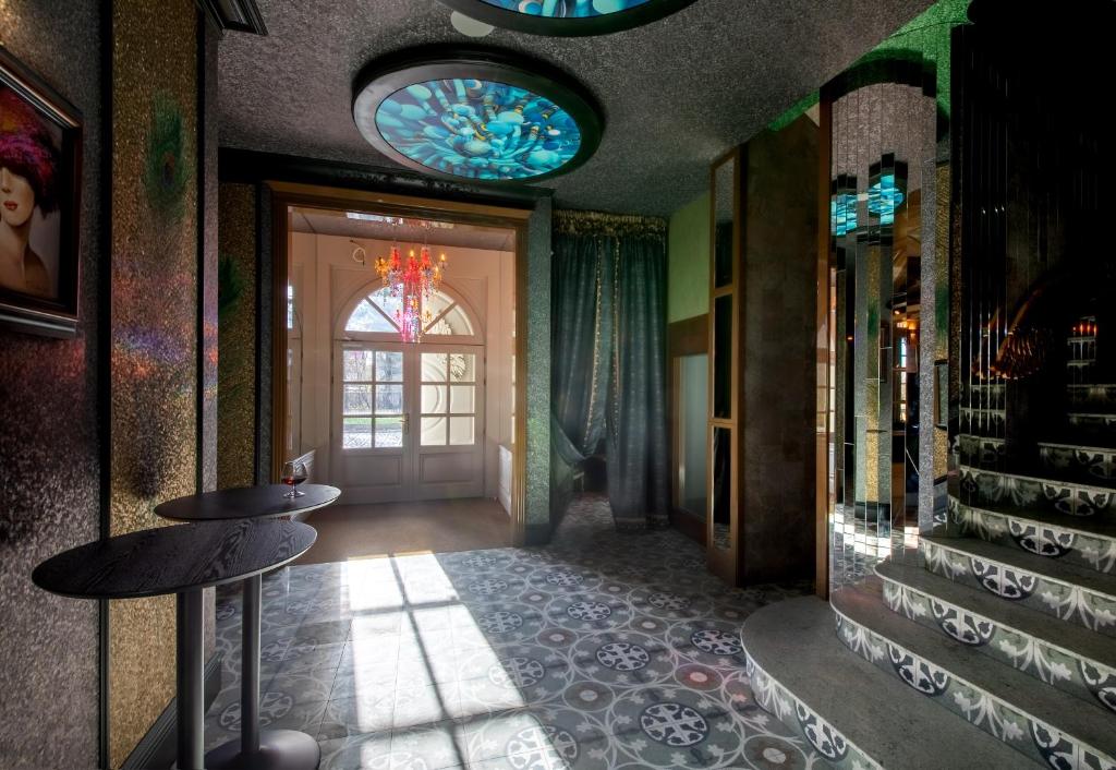 a hallway with a staircase and stained glass windows at AURORA Tarnów in Tarnów