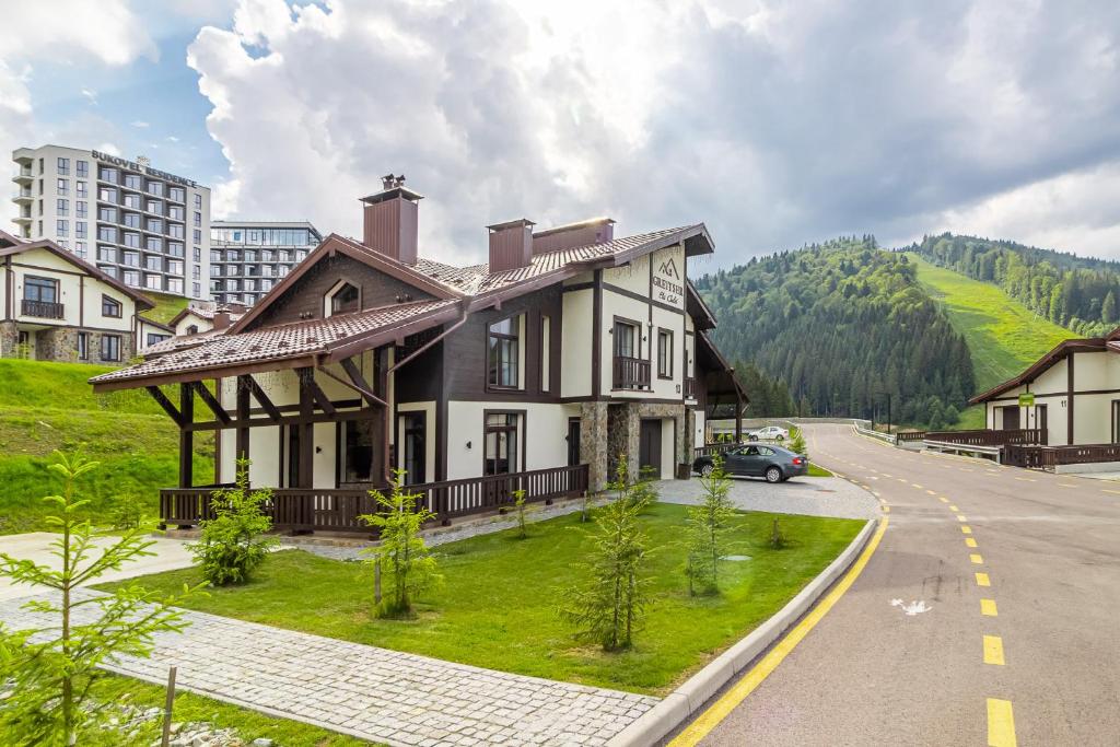 a large house on the side of a road at Greitser Elit Chalet in Bukovel