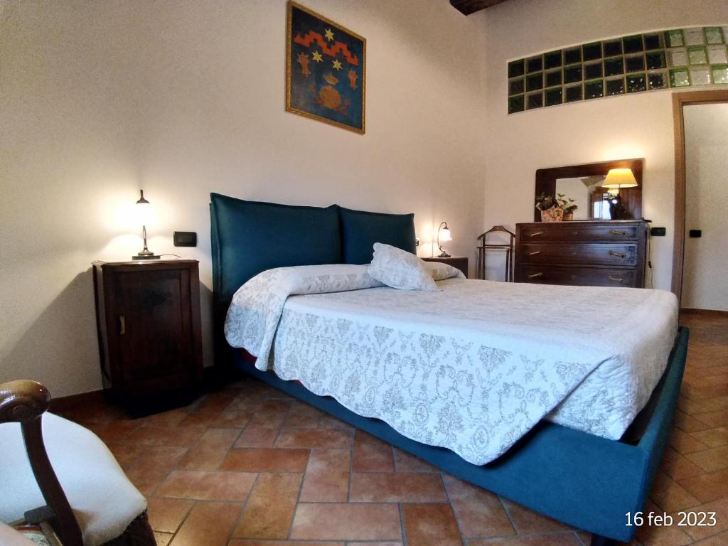 1 dormitorio con cama, tocador y espejo en Dietro Le Mura, en Colle Val D'Elsa