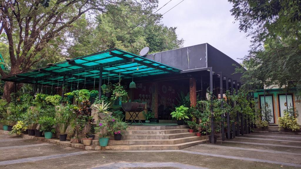 a building with stairs and potted plants at Haritha Holidays in Minneriya