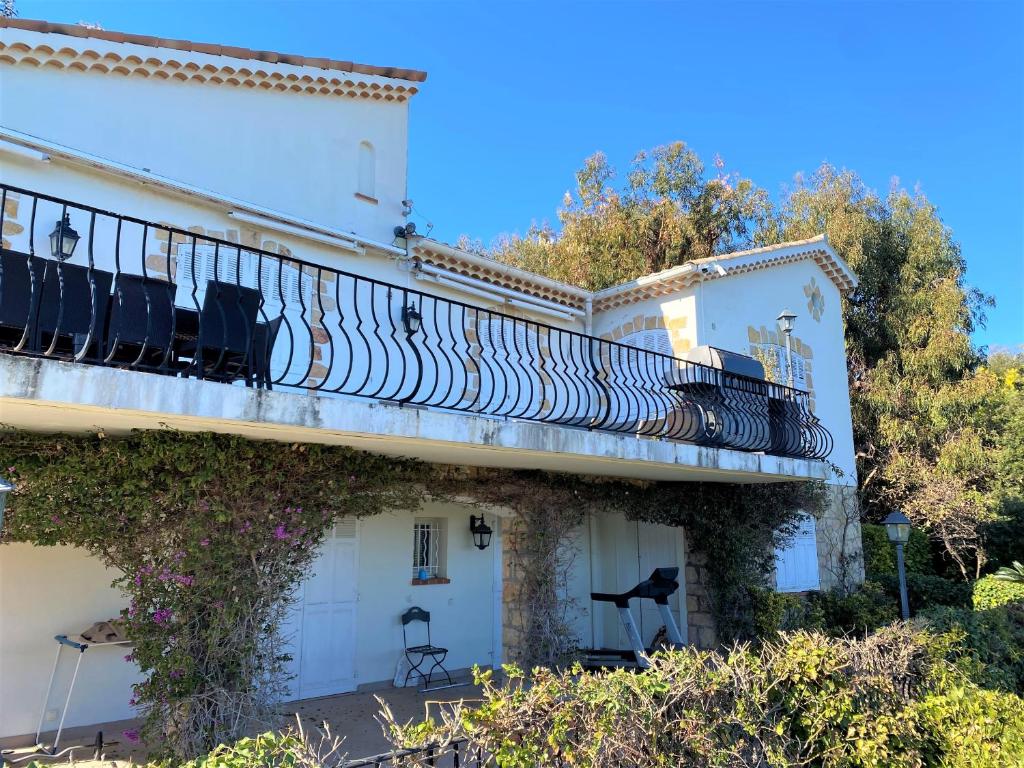 a white building with a balcony at VILLA LE MAS D&#39;AZUR BY ESTATESCANNES in Vallauris