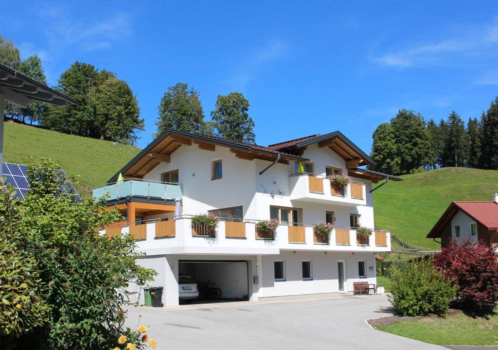 a large white building with balconies on a hill at Appartements Naturnah in Schladming