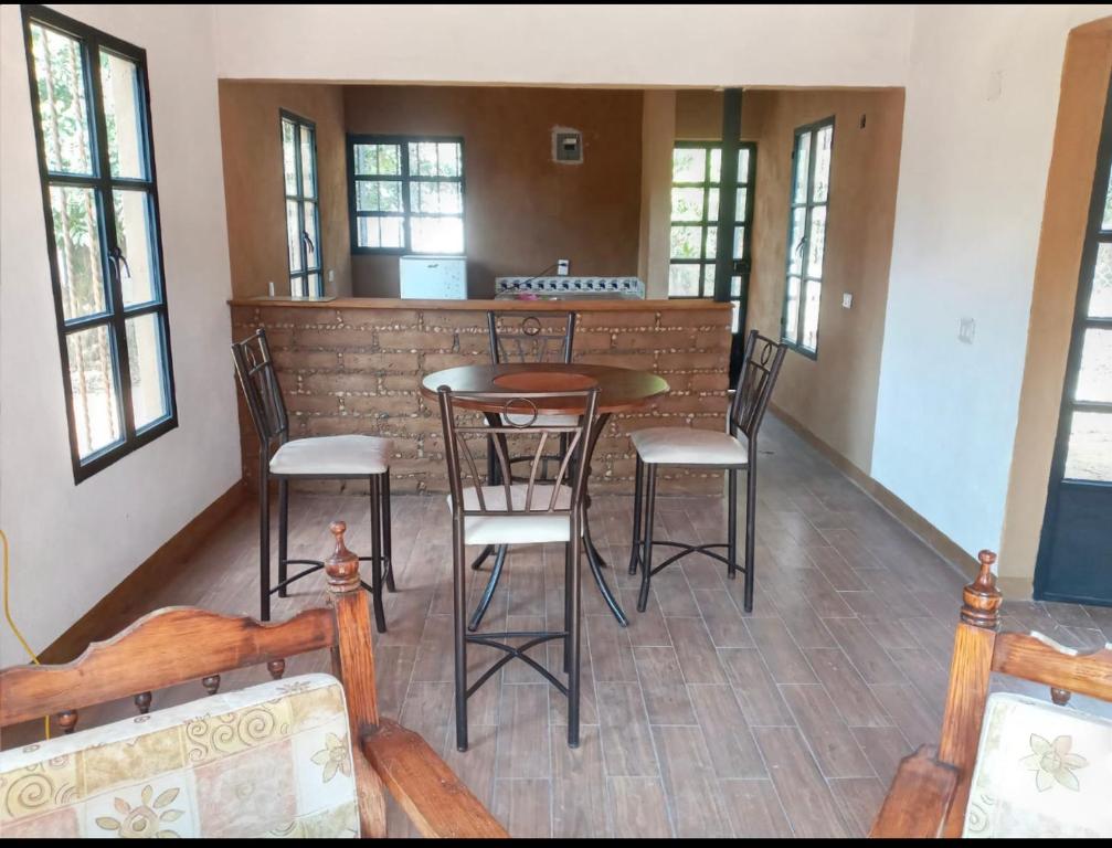 a bar in a room with chairs and a table at casa DON JULIAN in Tepoztlán