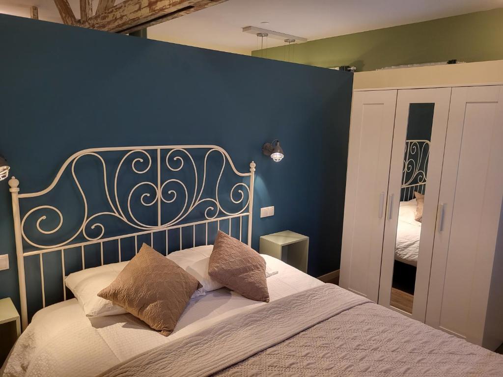 芬洛的住宿－Heerlijk Appartement 'la bienvenue' in Venlo, Limburg，一间卧室配有一张蓝色墙壁的床