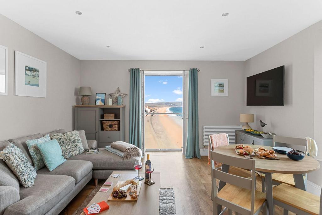 a living room with a couch and a table at 11 At The Beach in Beesands
