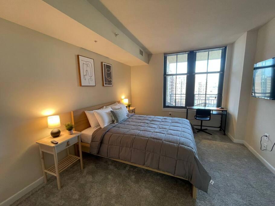 a bedroom with a bed and a desk and two lamps at Beautiful 1 Bedroom Apartment at Pentagon City in Arlington