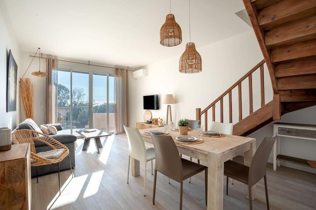 - un salon avec une table et des chaises en bois dans l'établissement Duplex Mandelieu, à Mandelieu-la-Napoule