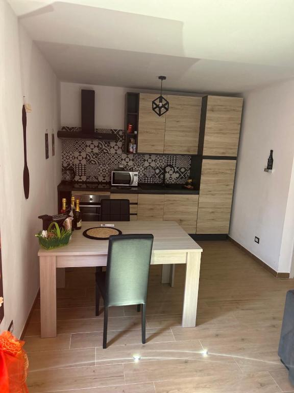 a kitchen with a table and chairs in a room at Stella Marina in Fertilia