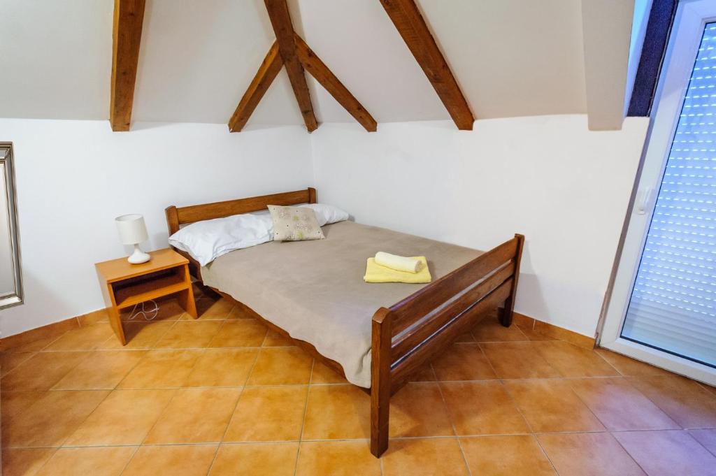 una camera con letto, tavolo e finestra di Apartments & rooms Lucie a Posedarje (Possedaria)