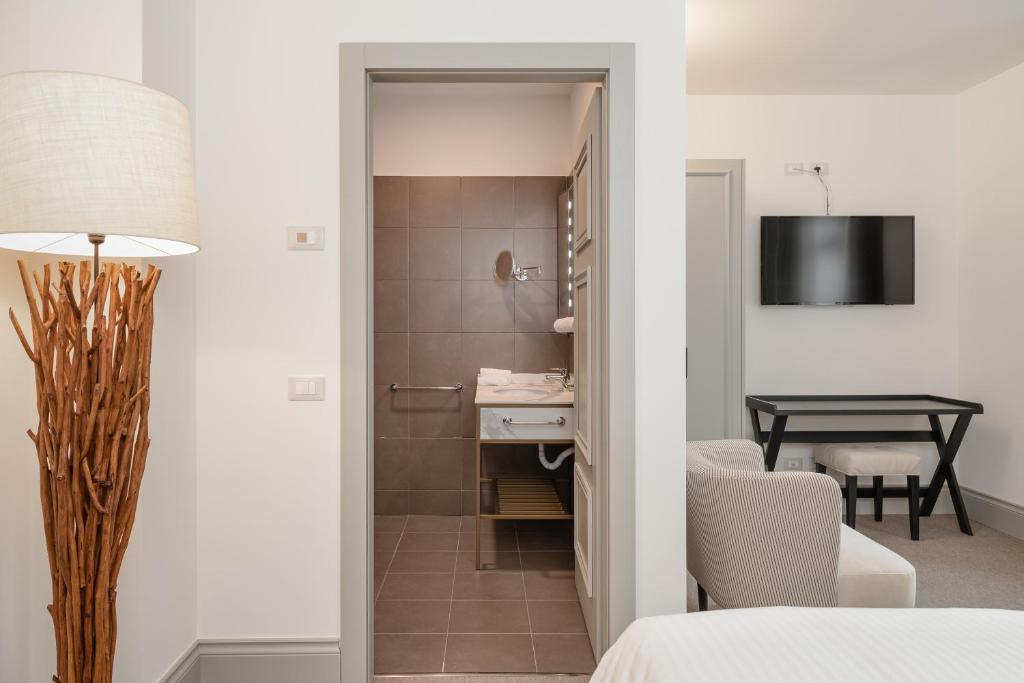 Postel nebo postele na pokoji v ubytování Villa Carona Hotel & Spa