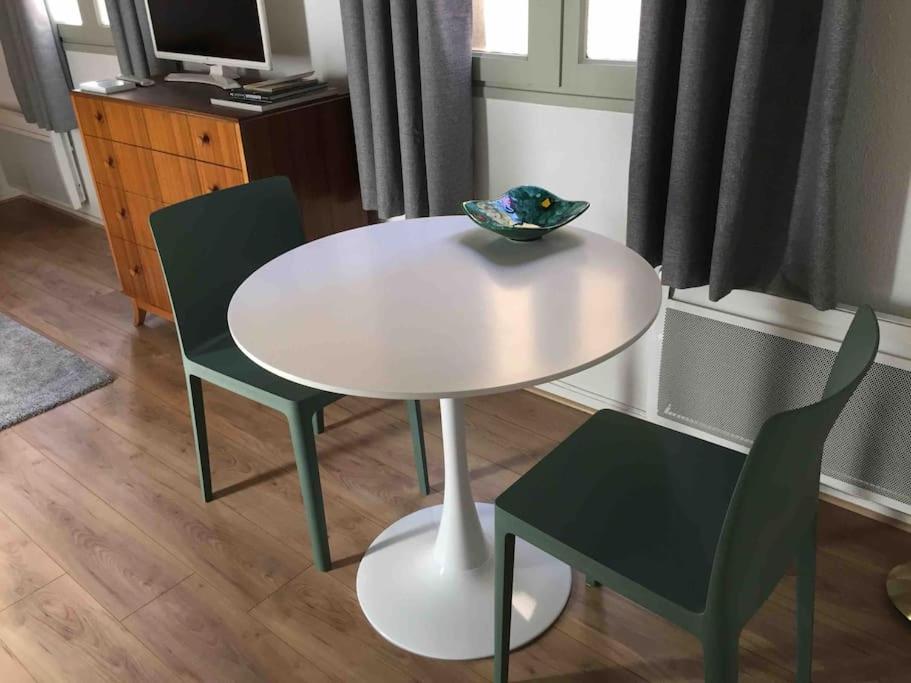 Biały stół z dwoma krzesłami i miską na nim w obiekcie Studio Anna centre historique Bordeaux St Pierre w mieście Bordeaux