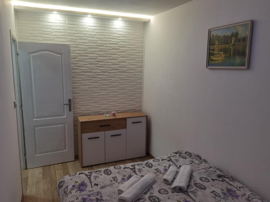 1 dormitorio con cama, mesa y puerta en Apartment Splendid, en Belgrado
