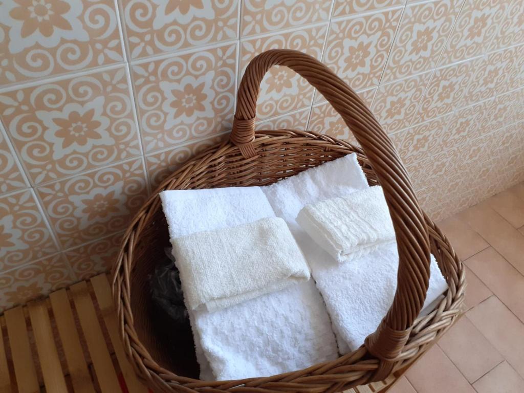 a basket filled with towels in a bathroom at Residenza La Lanterna in Genoa