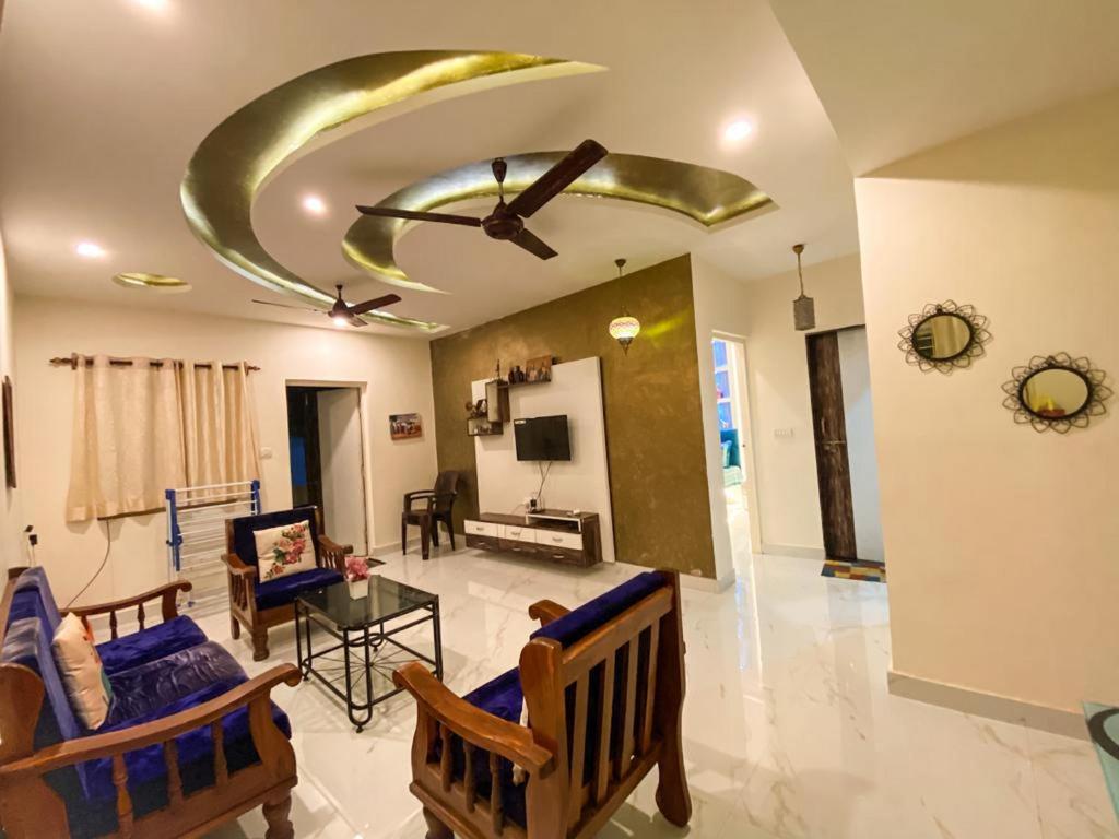 a living room with a couch and a ceiling at Moroccan Suite Calangute Beach Vibe in Calangute