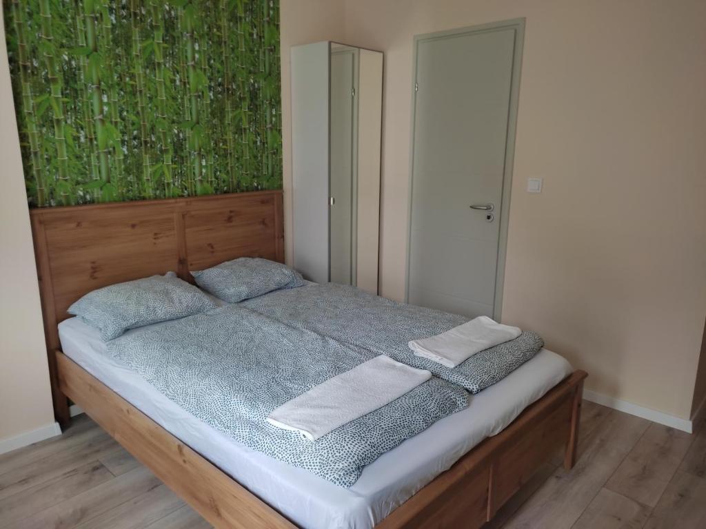 ein Schlafzimmer mit einem Bett mit zwei Handtüchern darauf in der Unterkunft Bamboo Apartman in Siófok