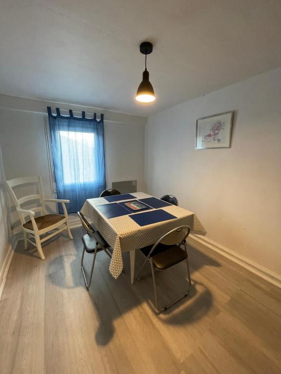 a dining room with a table and chairs and a window at Chez Pierre in Vitry-le-François