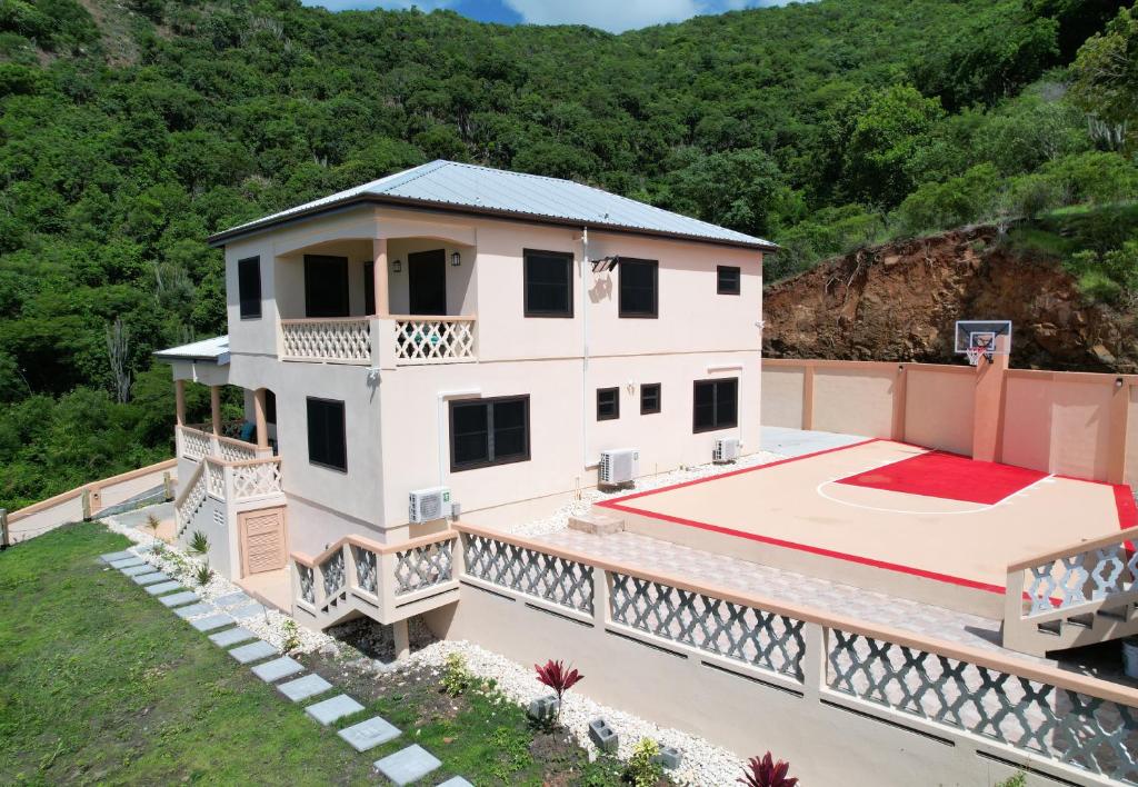 an aerial view of a house with a basketball court at The Pearl - Spacious Air Conditioned 3BD, 2BTH Villa with Gorgeous Views in Old Road