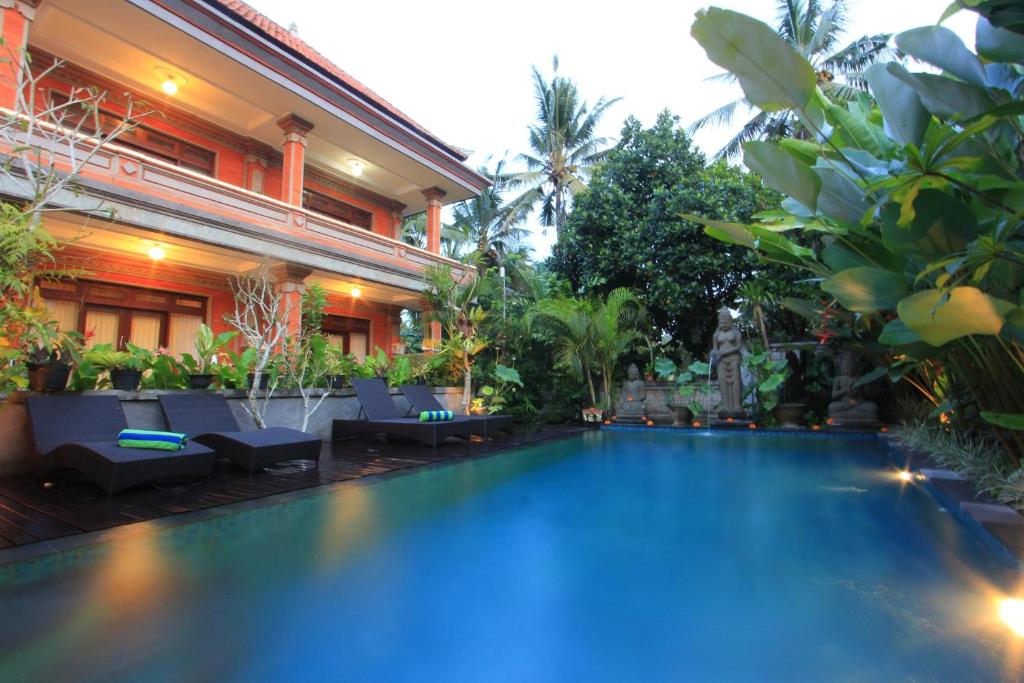 a swimming pool in the middle of a resort at Tanah Semujan Ubud in Ubud