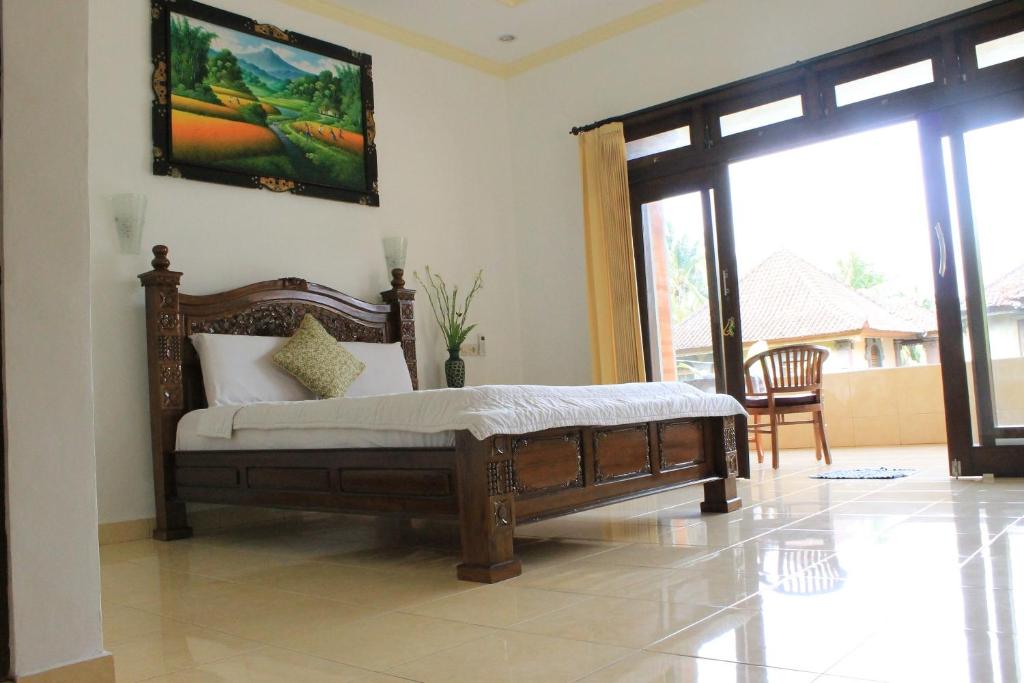 Postel nebo postele na pokoji v ubytování Tanah Semujan Ubud