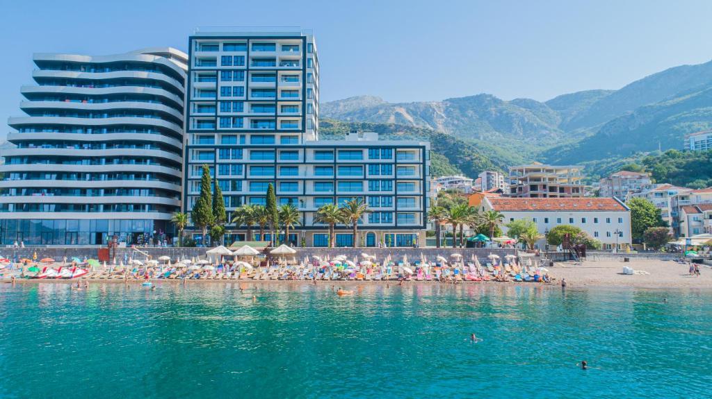 a group of people on a beach in the water at Montesun RAF Apartments in Budva
