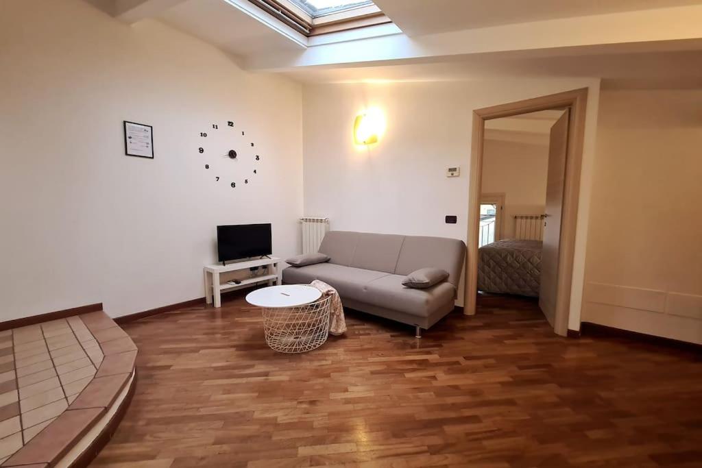 a living room with a couch and a tv at La Mansarda di Cremona in Cremona