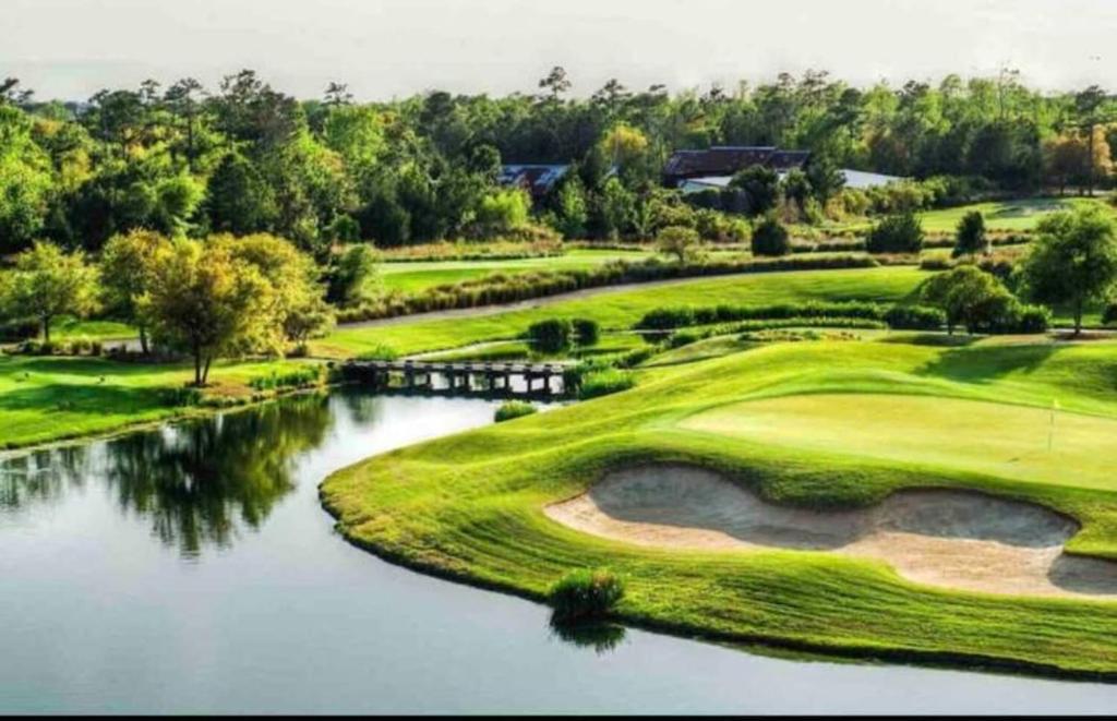 a view of a golf course with a river at Barefoot Beach Haven at Barefoot Resort & Golf - 3rd Floor- Close to Everything in North Myrtle Beach