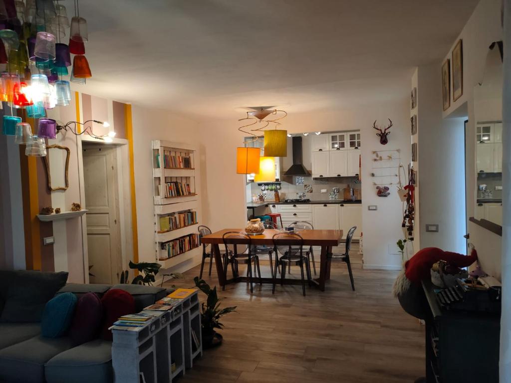 a living room with a table and a kitchen at La casa di Piera e Gina in Perugia