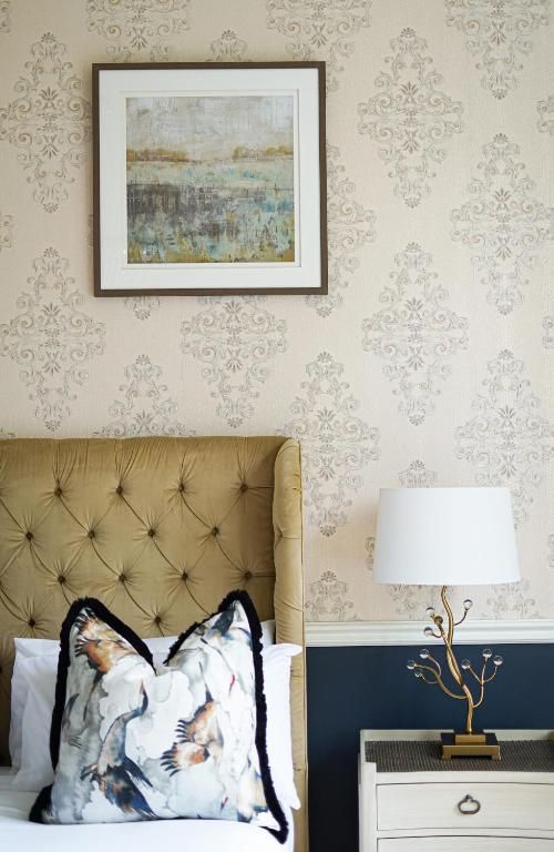 a bedroom with a bed and a picture on the wall at 40 Winks Hospitality in Durham