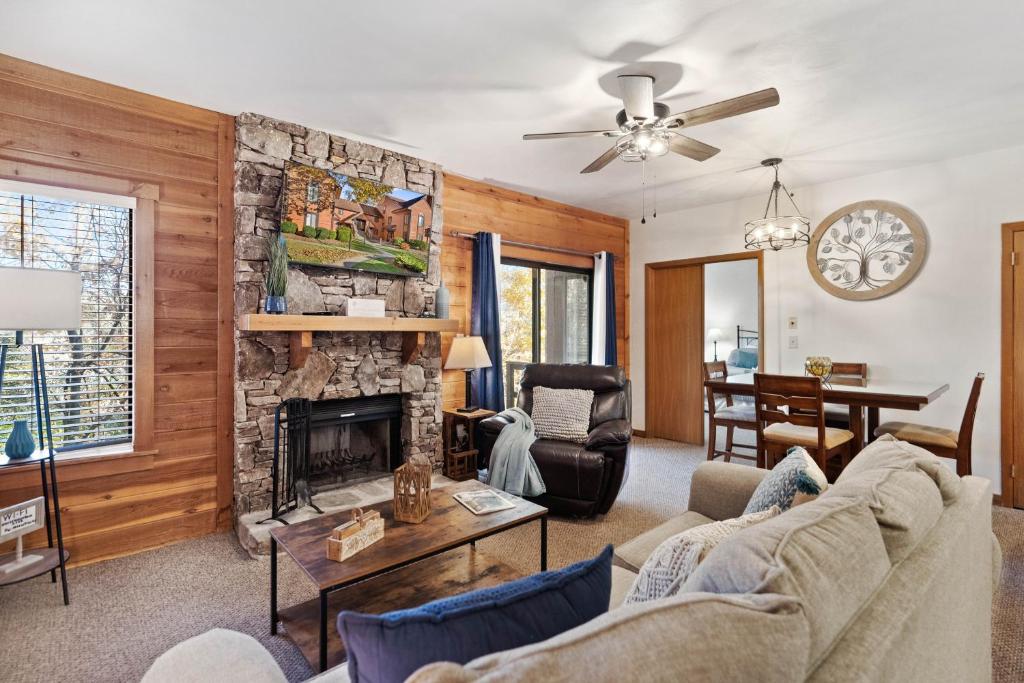 a living room with a stone fireplace at Beautiful Seven Springs- 2 Bed, 2 Bath Condo in Champion