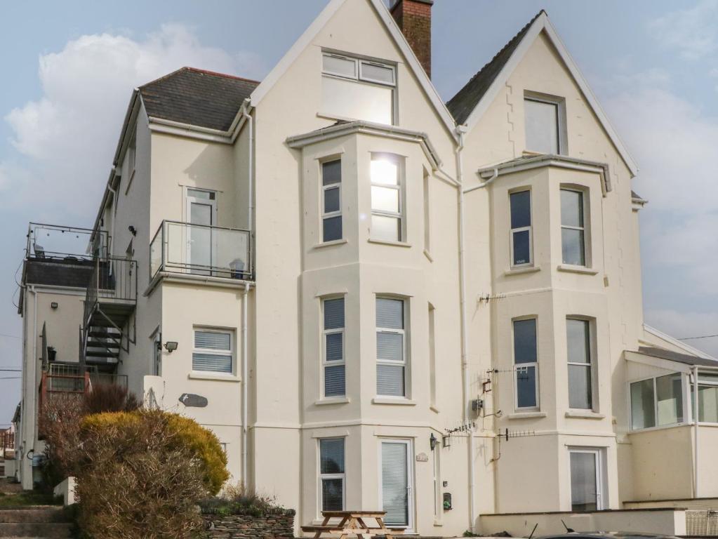 a large white house with a balcony at 5 Seymour Villas in Woolacombe